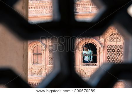 JODHPUR RAJASTHAN INDIA - MARCH 05 2016: Horizontal picture from behind the window of india men at Mehrangarh Fort in Jodhpur the blue city of Rajasthan in India.