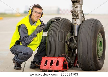 airport worker mechanic service maintenance chassis tire