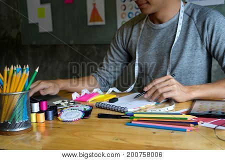 Young Fashion Designer Work On The Table