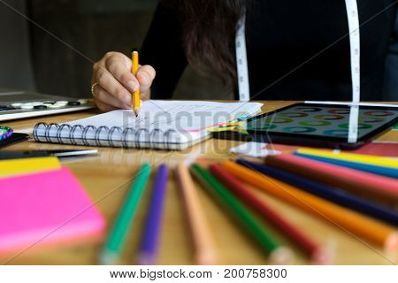Young Fashion Designer Work On The Table