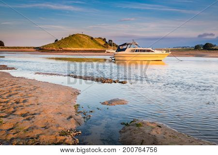 Church Hill across River Aln Estuary, as the river approaches the North Sea at Alnmouth, now tidal there are several boats moored in the estuary