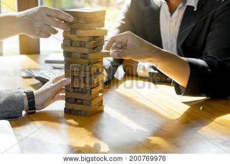 Businessman And Businesswoman Group Plan And Play Jenga Wooden Box