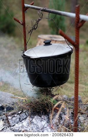 Cooking at the stake in the cauldron. Tourism. Meals in the open air.