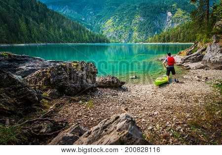 Scenic Lake Kayak Tour. Caucasian Men Enjoying the View From the Lake Shore. Tyrol Austria.
