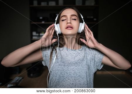 Beautiful young melomaniac. Audio book listening. Self-study courses, sexy female enjoying music in headphones