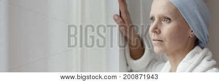 Woman With Cancer Looking Through Window