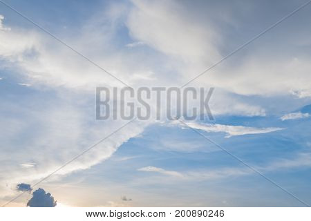 Sunset with white wispy cirrus and cirrostratus clouds