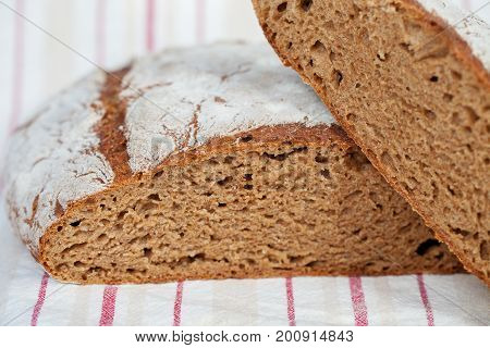 Sliced homemade rye bread on a traditional cloth
