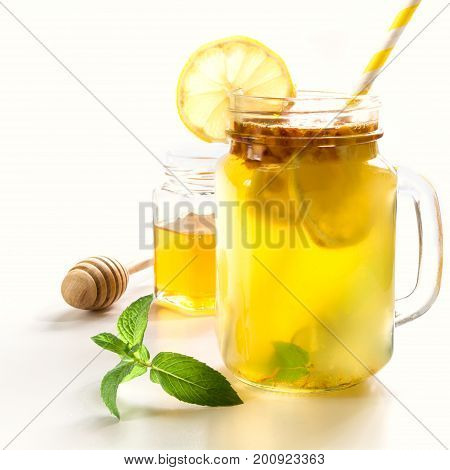 Healthy drink of seabuckthorn lemon and mint in mason jar on white background.
