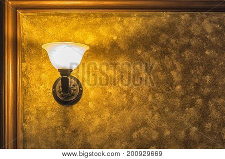 Old Vintage Lamp On The Wall With Framed Yellow Background