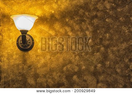 Old Vintage Lamp On The Wall With Framed Yellow Background