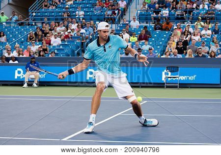Mason Ohio - August 13 2017: John Isner in a first round match at the Western and Southern Open tennis tournament in Mason Ohio on August 13 2017.