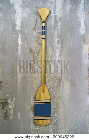 A well-detailed shot of a concrete wall with some texture to use as a background image or a texture for 3D rendering. A wooden paddle hung on it