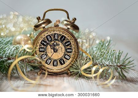 Old Alarm Clock Showing Five To Midnight. Happy New Year!