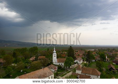 Aerial drone view of  a small village and his church before stom