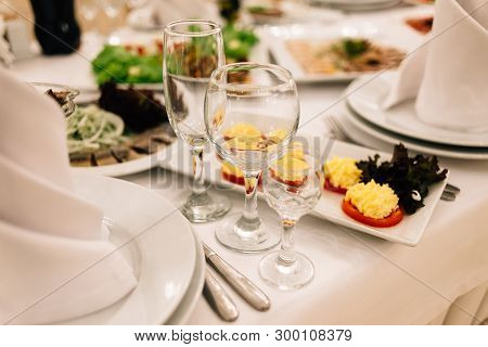 On A White Tablecloth There Are Three Wine Glasses