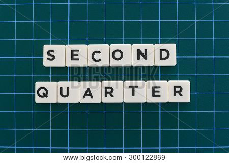 Second Quarter Word Made Of Square Letter Word On Green Square Mat Background.