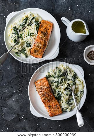 Healthy Balanced Lunch - Creamy Spinach Orzotto And Baked Salmon On A Dark Background, Top View