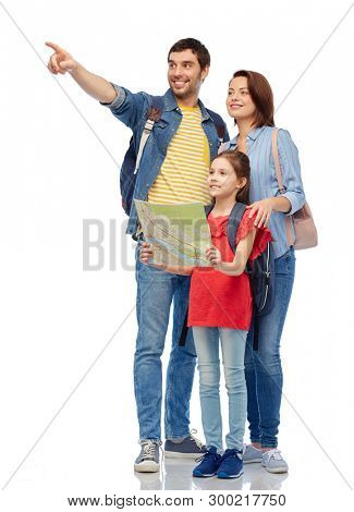family, tourism and travel concept - happy smiling mother, father and little daughter with map and backpacks over white background