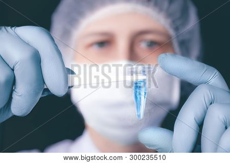 Scientist Or Tech Holds Liquid Biological Sample In Gloved Hands
