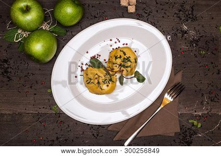 Meat Dish On A Plate On A Background With Green Apples