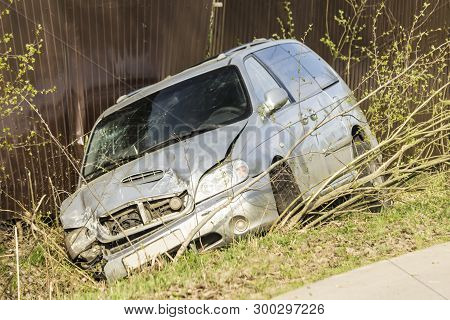 Car Accident On A Country Road. The Car Is Broken In Front, Slid Into A Ditch And Damaged A Metal Fe