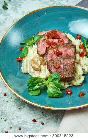 White Rice With Beef. Rizzotto. Gray Light Textured Background. Beautiful Serving Of Dishes