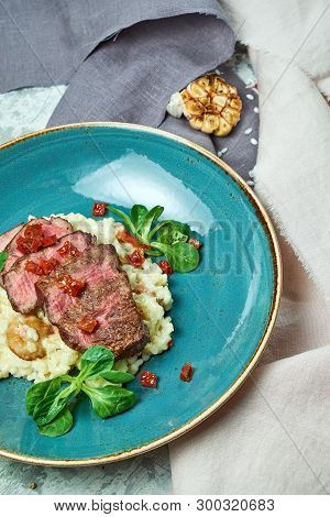 White Rice With Beef. Rizzotto. Gray Light Textured Background. Beautiful Serving Of Dishes