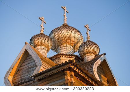Domes Of The Ancient Wooden Church Of Dmitry The Theunal Myrrh-streaming Close-up Against The Blue S