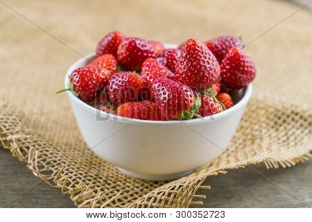 Red Strawberry Fruit In Bowl On Sackcloth.