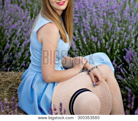 Girl In Lavender Whith  A Hat 
Sitting On The Stac