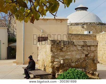 Nicosia, Cyprus - 19 January, 2019: A Woman Is Resting On A Bench Outside The Omerye Hamam In The Ol