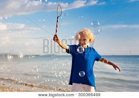 Kids Blow Bubble At Beach. Child With Bubbles