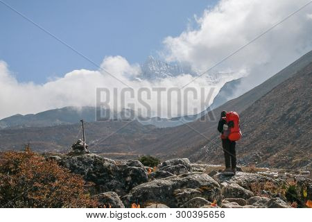 Unidentified Tourist Trekking In Nepal Walking From Dingboche To Chukung Within Sagarmatha National 