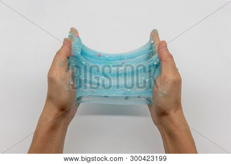 Hand Strecthing Transparent Blue Glitter Slime Isolated On White Background
