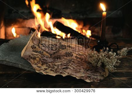 Treasure Map Over A Burning Fire Background. Treasure Hunt Concept.