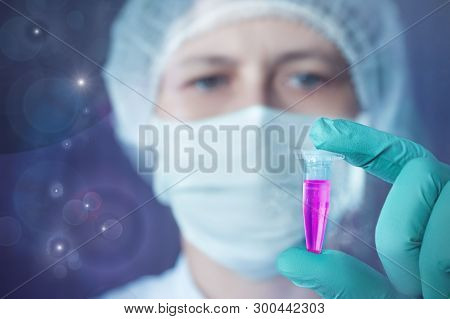 Scientist Or Tech Holds Liquid Biological Sample In Gloved Hands