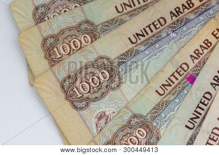 The Currency Of The United Arab Emirates (uae) - Thousand Dirham Notes Spread Out On A White Backgro