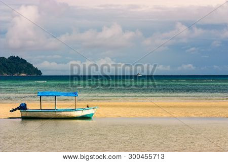 Blue And White Boat With Canopy Isolated On The Beach With Cloudy Sky At Havelock Island, Andaman An