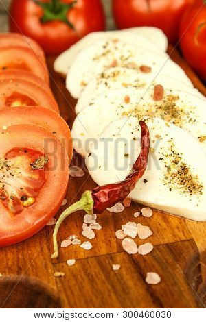 Fresh Mozzarella Cheese And Tomatoes Onkitchen Cutting Board. Healthy Diet Food. Chili Peppers With 