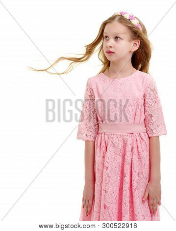 Happy Little Girl In A Lush Flowing Dress, Spinning. Her Hair Is Flying In The Wind. The Concept Of 
