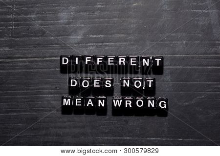 Different Doesn't Mean Wrong On Wooden Blocks. Education, Motivation And Inspiration Concept
