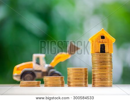 House Or Home Model On Top Of Coins Stack. Concept For Loan, Property Ladder, Financial, Mortgage, R