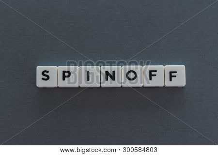 Spinoff Word Made Of Square Letter Word On Grey Background.