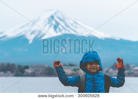 Kid Is Standing In Front Of Kawaguchiko Lake And Mount Fuji In Winter.