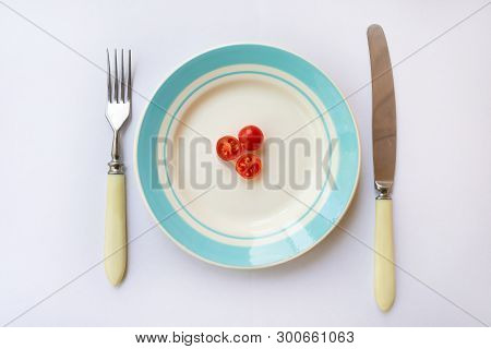 Plate With Cherry Tomatoes. Concept Of Hard Dieting And Weight Loss.
