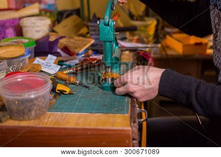 Professional Male Skinner, Tanner Working With Genuine Leather Belt At Workshop, Studio. Handmade An
