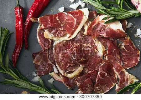 Hamon.tasty Ham Sliced ​​into Strips On A Wooden Background With Spices And Fresh Thyme. A Serving O
