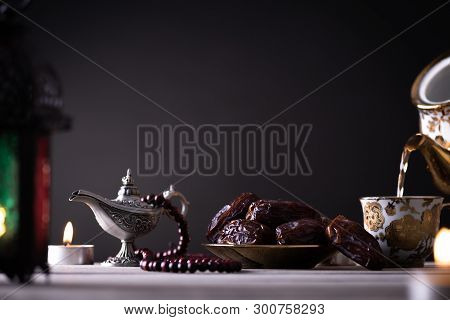 Ramadan Food And Drinks Concept. Ramadan Lantern With Arabian Lamp, Wood Rosary, Tea, Dates Fruit An