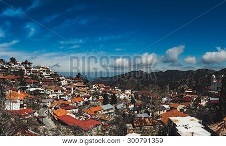 Pedoulas Village On Cyprus In Troodos Mountains With Blue Sky And Copy Space. Panoramic View.